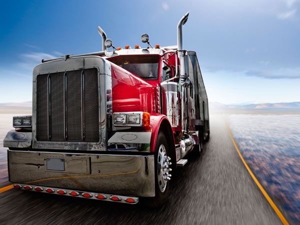 Long‑haul truck on highway at sunset